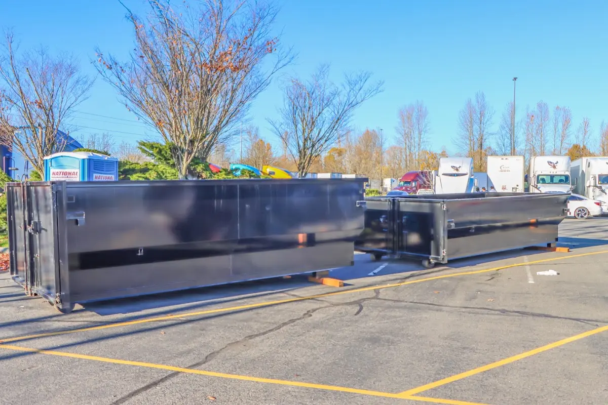 Professional dumpster rental service with roll-off container on residential driveway in Bacliff